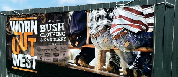 Outdoor vinyl banner mounted on a storefront