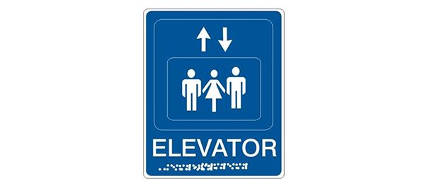 Tactile exit sign sample with raised lettering and braille