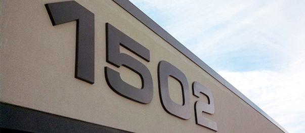 Raised dimensional letters spelling a business name on an interior wall