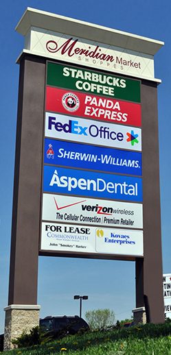 Custom-shaped pylon sign with painted cabinet and brand panels