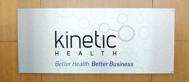 Metal-finish company name sign in a reception area