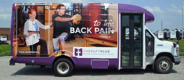 Bus wrapped in large-format advertising graphics