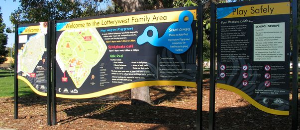 Wall-mounted directional signs with arrows guiding visitors through a building
