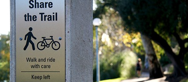 Wayfinding signs at a building entrance pointing to key areas