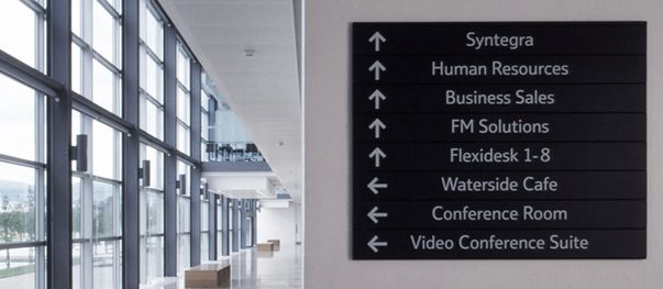 Branded directional signage directing visitors in a public space
