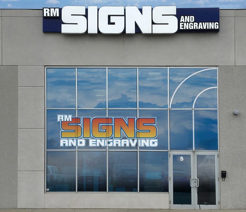 Storefront with illuminated sign lettering and window graphics